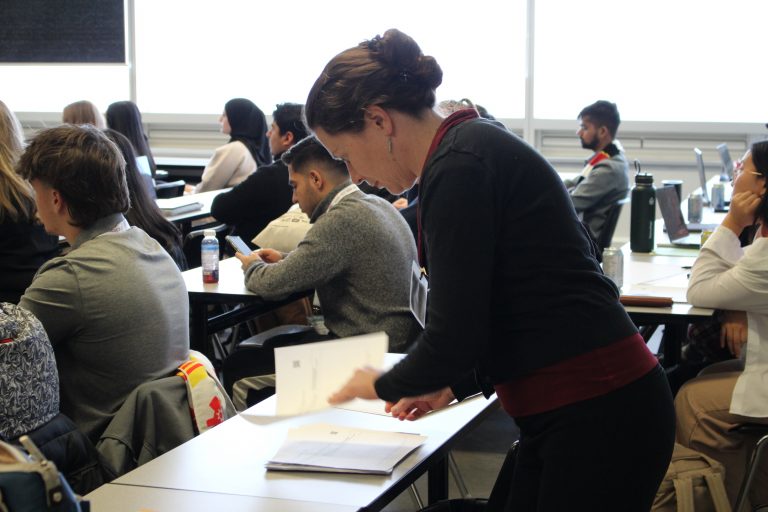 Dr. Heather Love flips through notes during a workshop.